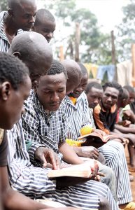 Inmates reading Bibles on the patio